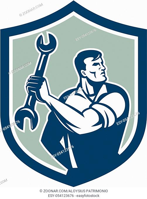Illustration of a mechanic clinching holding spanner wrench looking to the side set inside shield crest on isolated background done in retro style