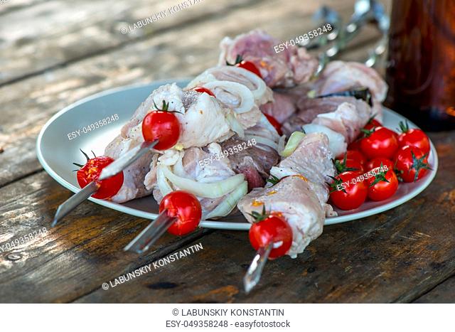appetizing meat shish kebab lies on the table, raw meat