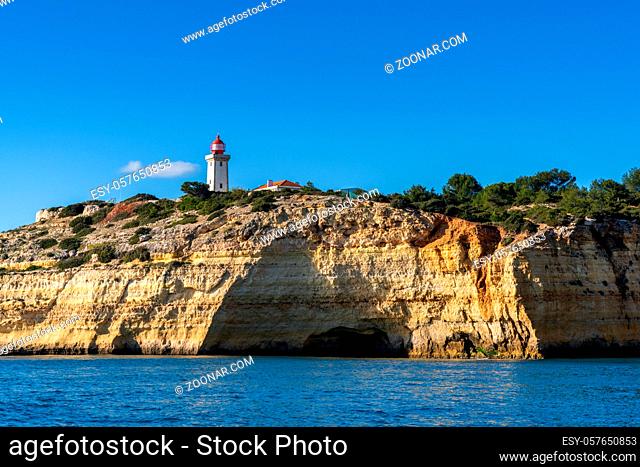 A view of the Alfanzina lighthouse on the beautiful Algarve coast of Portugal