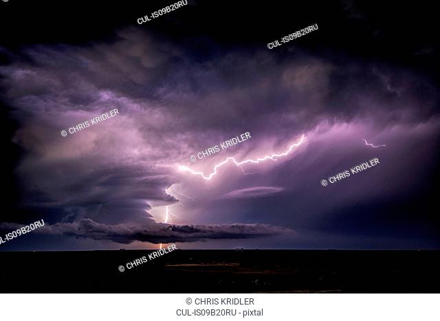 Lightning sparks from a spinning supercell thunderstorm at night near Leoti, Kansas