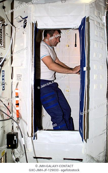 Cosmonaut Vladimir Dezhurov of Rosaviakosmos, Expedition Three flight engineer, works on a laptop computer in the Temporary Sleep Station (TSS) in the U