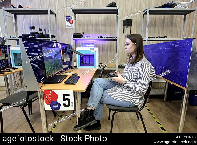 RUSSIA, ST PETERSBURG - MARCH 16, 2023: A student of GUAP St Petersburg State University of Aerospace Instrumentation tests a quadcopter (FPV drone) in a lab