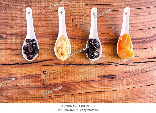 Mix of dried fruits over a rustic table