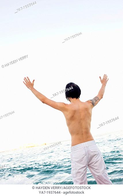 Man on Beach with Hands up