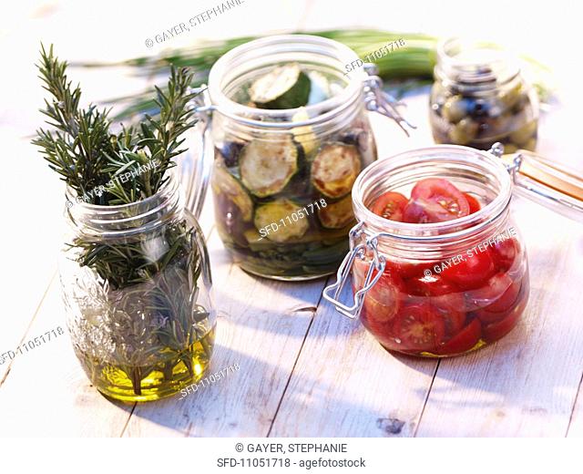 Preserved vegetables and herbs in jars