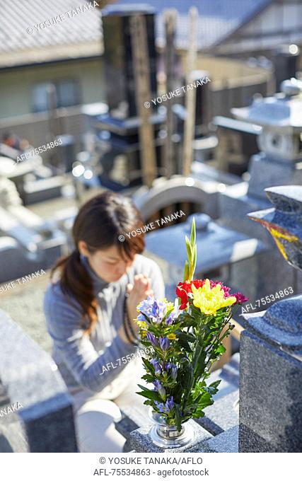 Japanese woman at a cemetery