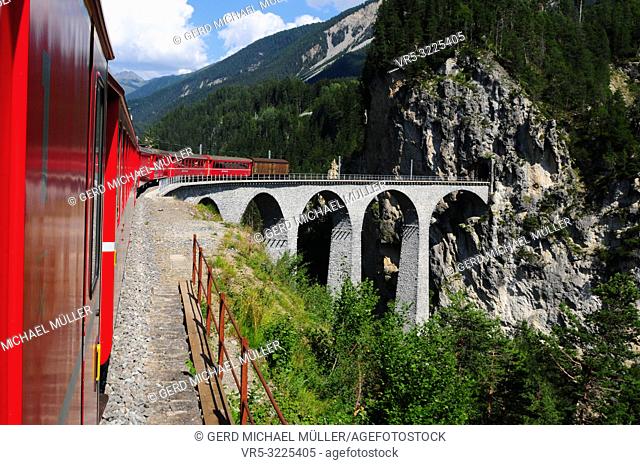 One way to the WEF: The Glacier Express Unesco World Heritage train trip through the swiss alps at the famous Landwasser-Viadukt