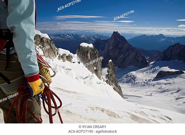 A female climber ascends the Northeast Ridge - North Howser, Bugaboos, BC