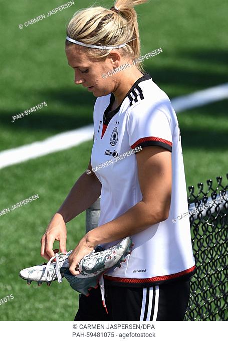 Germany-s Lena Goessling changes her shoes during a training session at the FIFA Women's World Cup 2015 at the Avenue Bois-de-Boulogne, Laval in Montreal