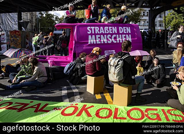 17 September 2022, Berlin: Members of the environmental protection group Extinction Rebellion block the intersection at Schlesisches Tor