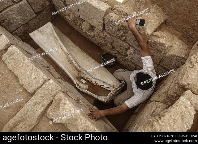 16 July 2023, Palestinian Territories, Beit Lahia: A member of a Palestinian excavation team working at a Roman-era cemetery in the northern Gaza Strip