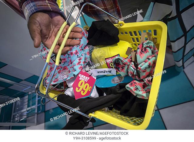 A shopping basket of ""merch"" in the AriZona Beverages ""Great Buy 99¢"" pop-up store in Soho in New York on opening day, Wednesday, May 16, 2018