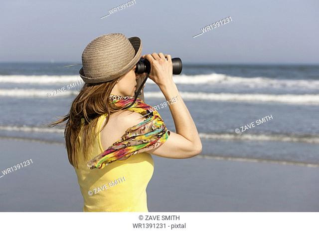 A woman in a sunhat and scarf on the beach on the New Jersey Shore, at Ocean City