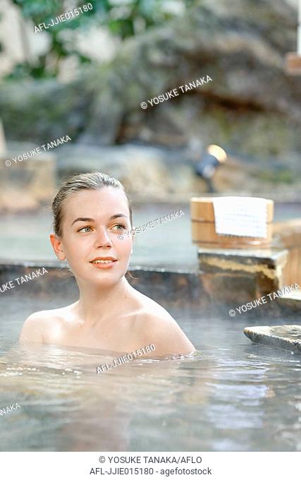 Caucasian woman bathing at traditional hot spring, Tokyo, Japan