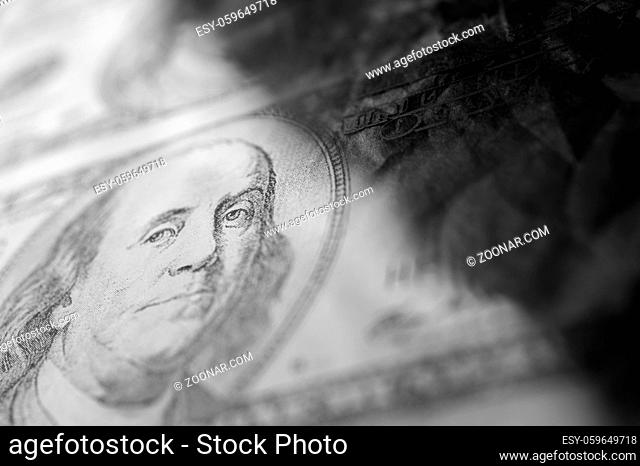 Close-up of Benjamin Franklin on the 100 dollars bill of grunge art abstract background. Dark, gloomy, crumpled. Economy trends background for business idea and...