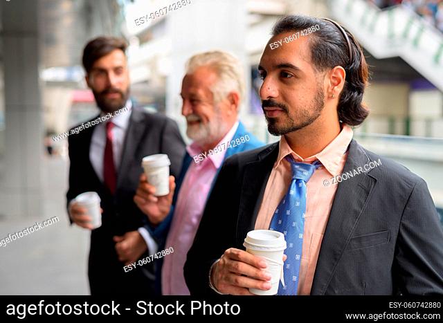 Portrait of three multi ethnic bearded businessmen together around the city of Bangkok