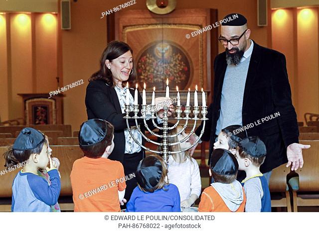 Rabbis Lauren Holtzblatt and Aaron Alexander talk with pre-schoolers about lighting the menorah the day before Hanukkah starts at the Adas Israel Congregation...