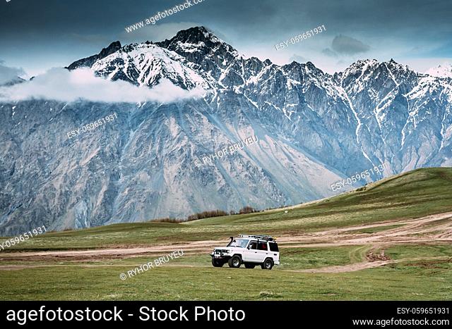 White SUV Car On Off Road In Spring Mountains Landscape In Georgia. Drive And Travel Concept. Landscape Of Gorge At Spring Season