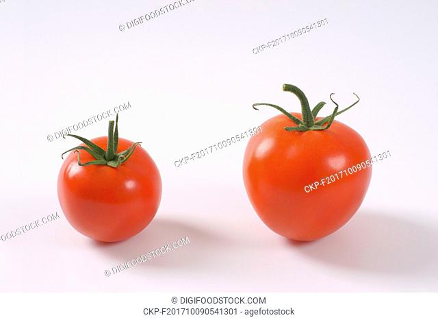 two ripe tomatoes on white background