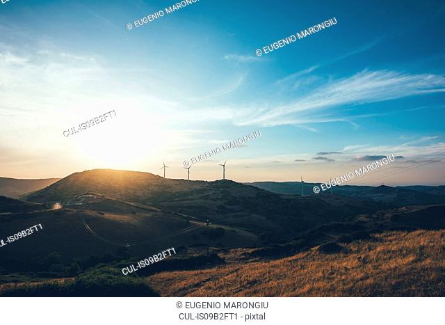 Sunset over wind turbines on rolling landscape, Osilo, Sassari, italy