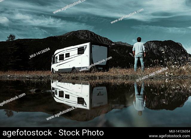 motorhome camper vehicle for transport and vacation parked near mountains, enjoying outdoors in travel and lifestyle
