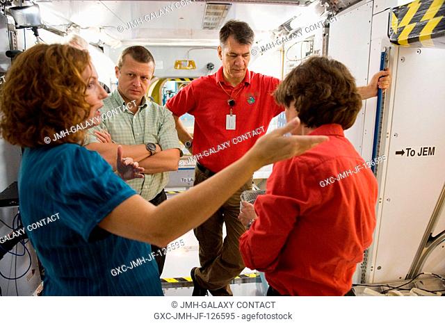 Russian cosmonaut Dmitry Kondratyev (left background), Expedition 26 flight engineer and Expedition 27 commander; NASA astronaut Catherine Coleman (right) and...