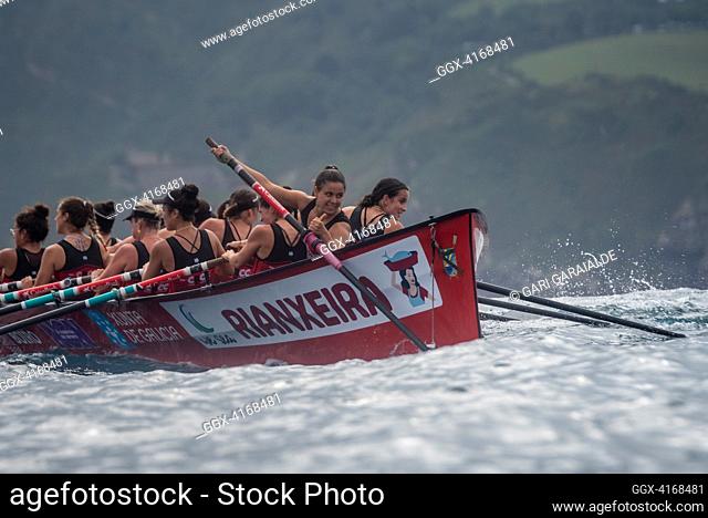 Crew of Cabo da Cruz rowing boat in action during XV Zarauzko Ikurrina women’s regatta of the ACT Euskotren League (The Association of Clubs of rowing boats)