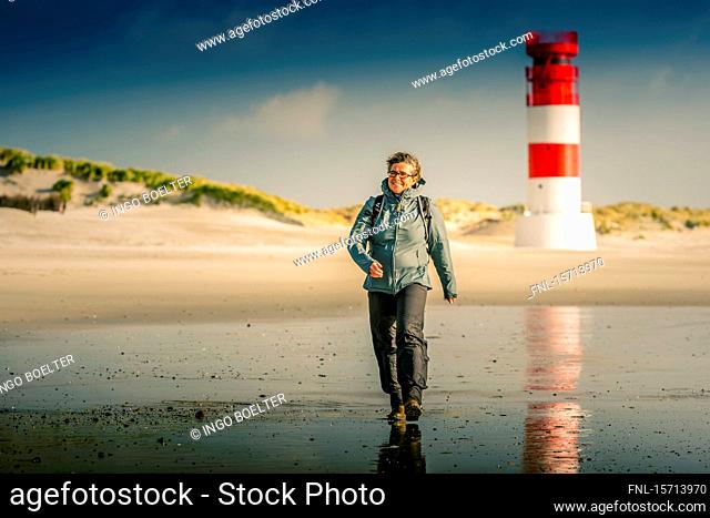Woman walking at beach, Helgoland, Schleswig-Holstein, Germany, Europe