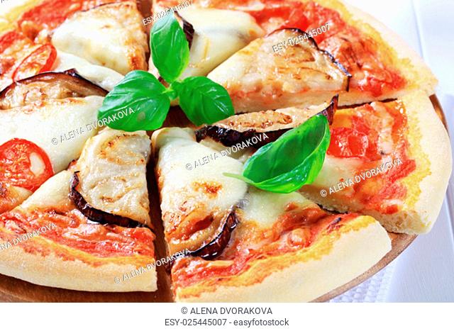 Pizza topped with cheese and slices of eggplant