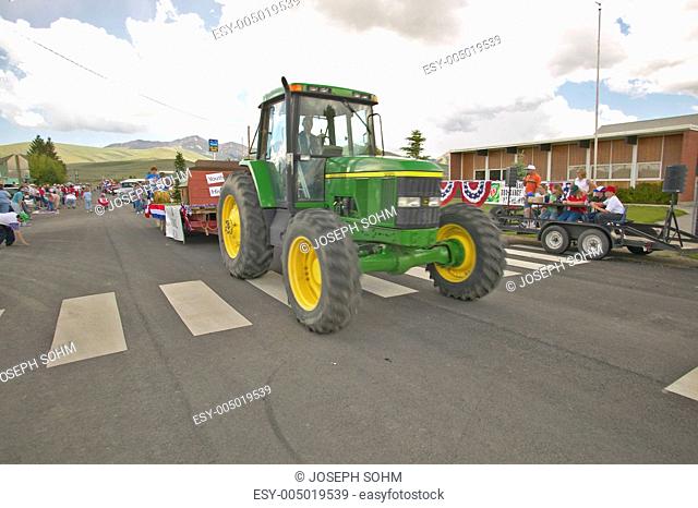 Tractor leading the Fourth of July parade down main street, in Lima Montana