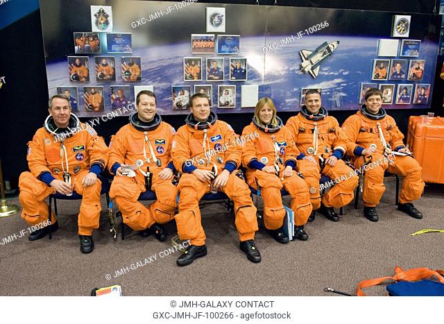 The STS-130 crew members, attired in training versions of their shuttle launch and entry suits, await the start of a training session in the Space Vehicle...