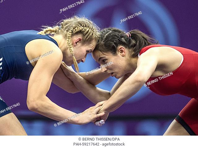 Aline Focken (blue) of Germany and Martina Kuenz (red) of Austria compete in the women's Freestyle 69kg wrestling Bronze Medal Final at the Baku 2015 European...