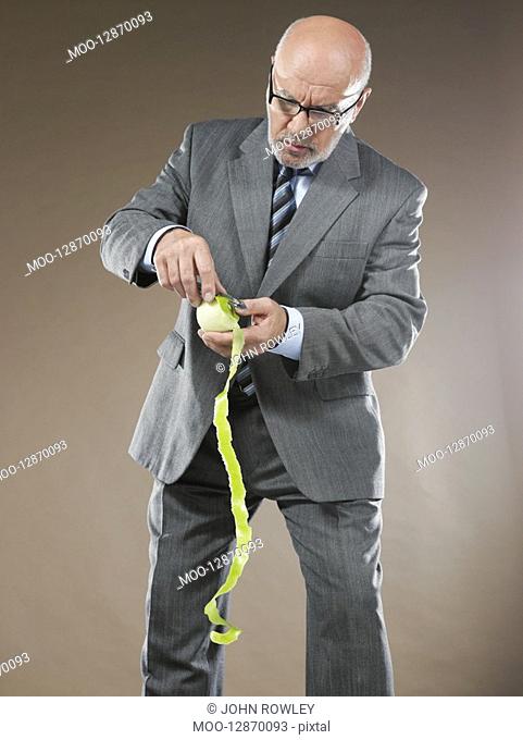 Businessman Peeling Apple