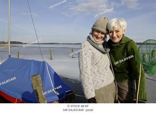 Portrait of two mature women with a dip net