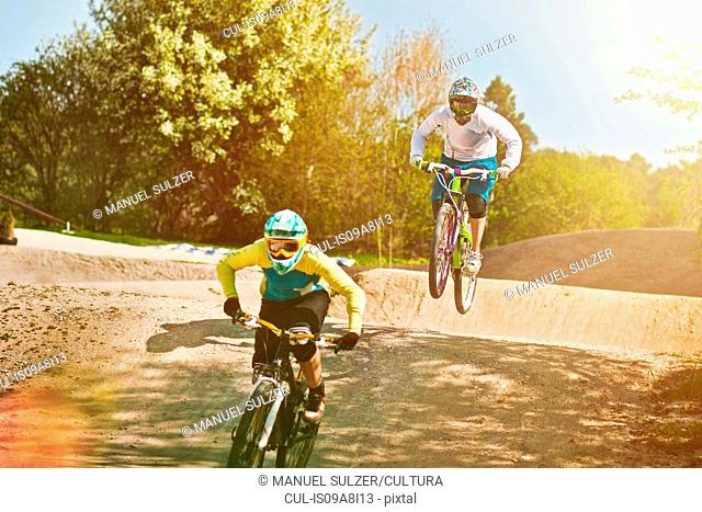 Cyclists riding on dirt bike course