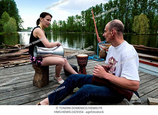 Estonia (Baltic States), Tartu region, Tartu, River Emajogi, Drummers on a boat