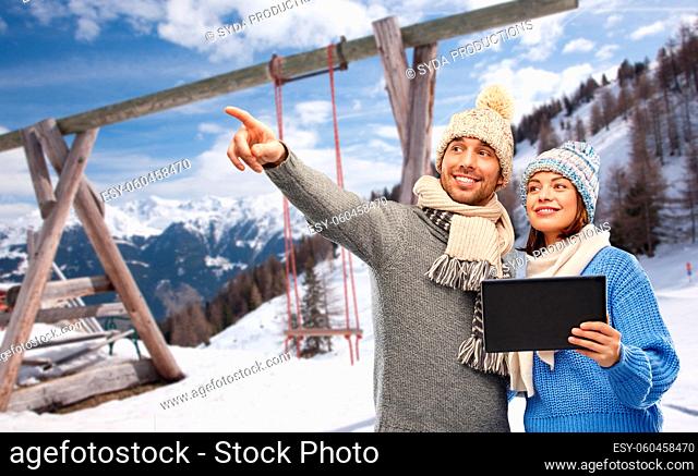 couple with tablet computer in winter