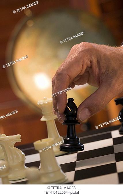 Hand moving chess piece