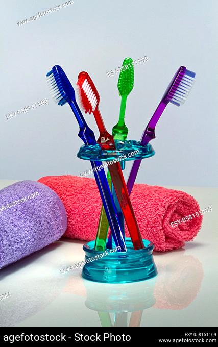 Toothbrush and bath towels against a white background in a studio environment