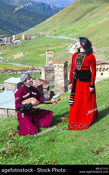 Georgian people from the folklore group playing panduri and dancing in traditional Georgian dress, For editorial purposes only, Ushguli, Svaneti region, Georgia