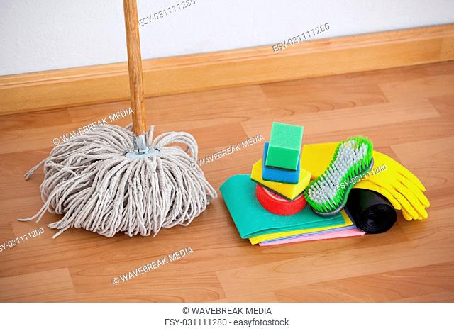 Mop and cleaning equipment on wooden floor