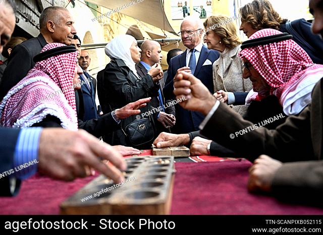 H.M King Carl XVI Gustaf and H.M. Queen Silvia watch as men play board games during a visit to the ancient city As-Salt, Jordan, November 16, 2022