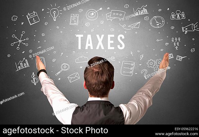 Rear view of a businessman with TAXES inscription, modern business concept