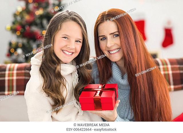 Daughter giving her mother a christmas present