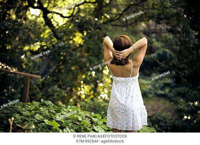 Beautiful young woman looking out into the forest