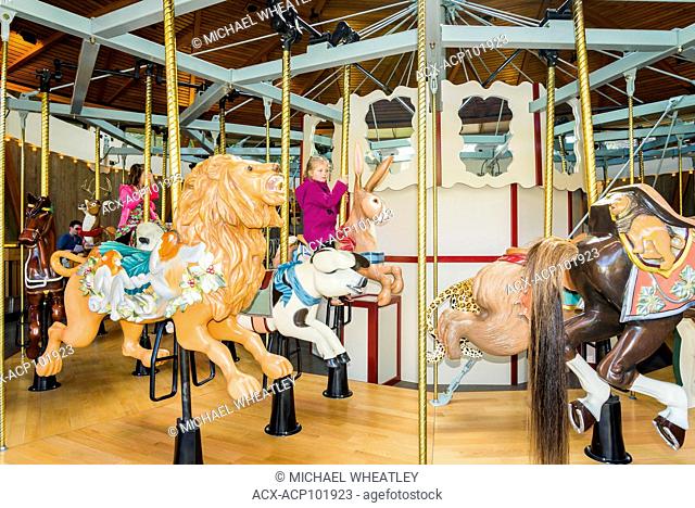 Young girls on carousel, Butchart Gardens, Brentwood Bay, Vancouver Island, British Columbia, Canada