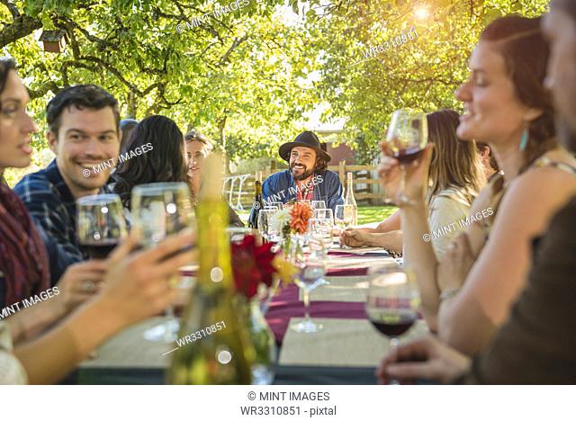 Friends drinking wine at party outdoors