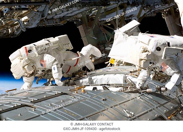 Astronauts Mike Fossum (left) and Ron Garan, both STS-124 mission specialists, participate in the mission's second scheduled session of extravehicular activity...