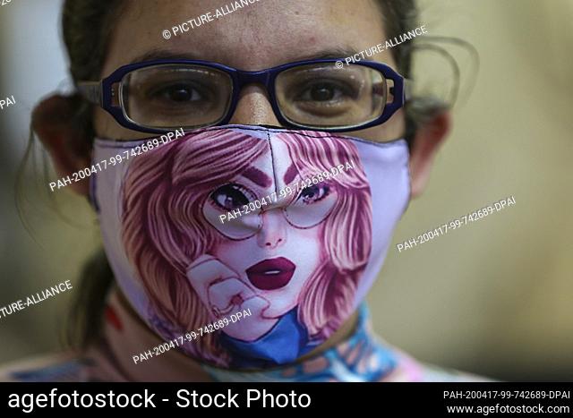 15 April 2020, Venezuela, Caracas: A woman is wearing a fashionable face mask in the middle of the corona pandemic. In the fight against the spread of the...