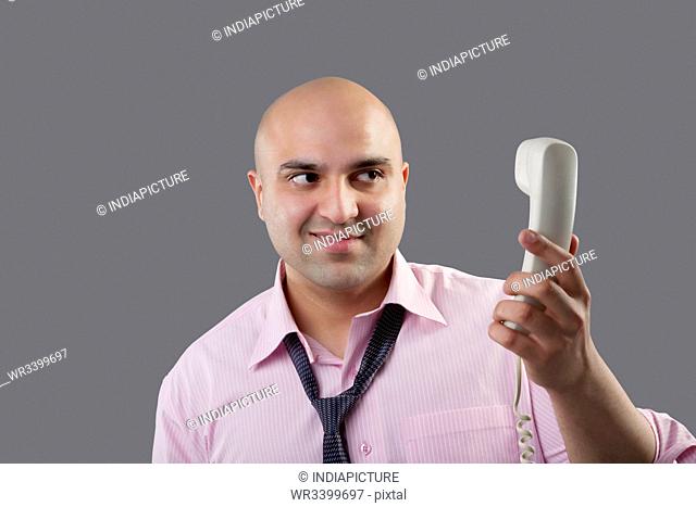 Executive holding a telephone
